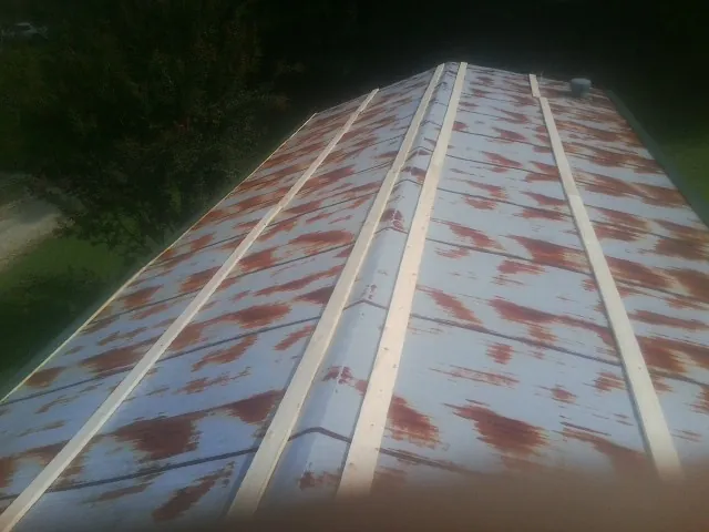Rusted metal roof panels with new wood purlins before replacement — Storm Damage Roof Repair in Blauvelt by Roofing Brothers