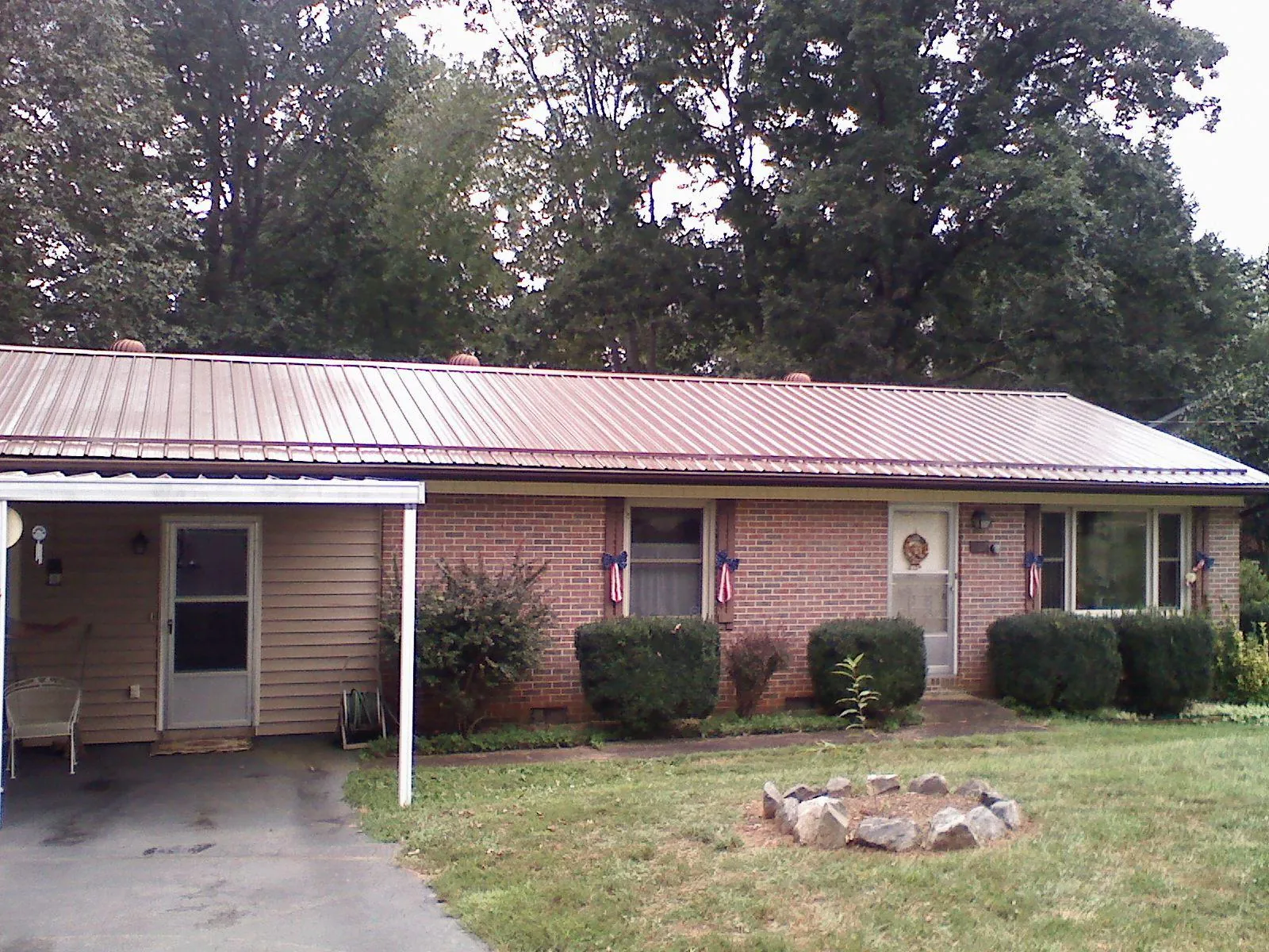 Bronze metal roof and carport on a brick ranch home — Roof Repair work by our crew in Blauvelt